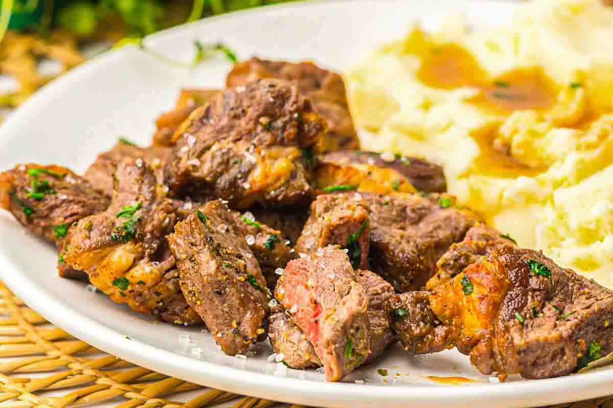 Plate of ribeye steak cubes and gravy.