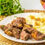 Ribeye steak cubes with mashed potatoes side.