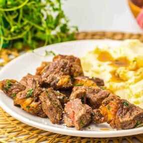 Ribeye steak cubes with mashed potatoes side.