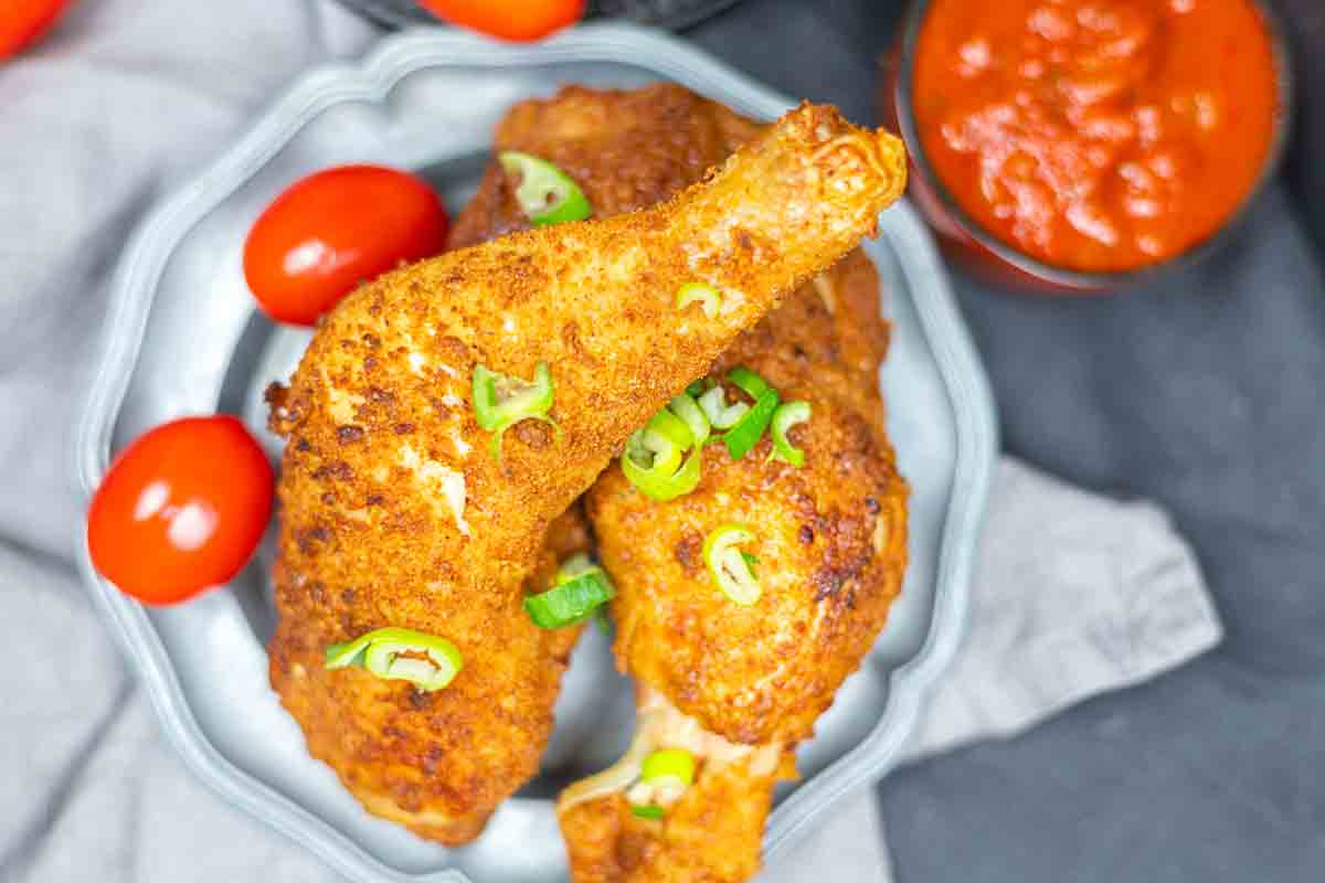 Overhead view of crispy reheated chicken legs.