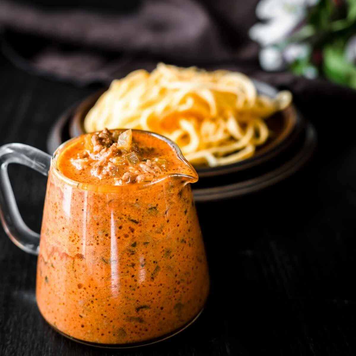 Close-up of smooth spaghetti meat sauce texture.